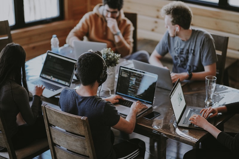 A team building together on laptops